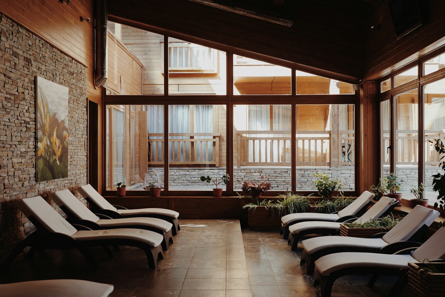 Lounge chairs in a relaxation area with stone and wood accents.